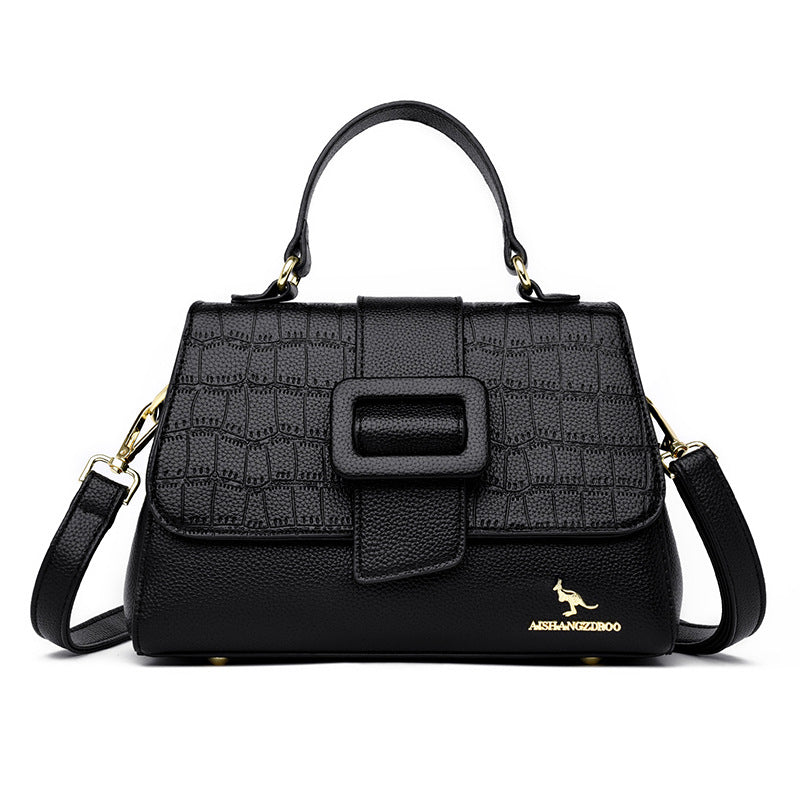 Black handbag with textured pattern and visible brand logo on a white background