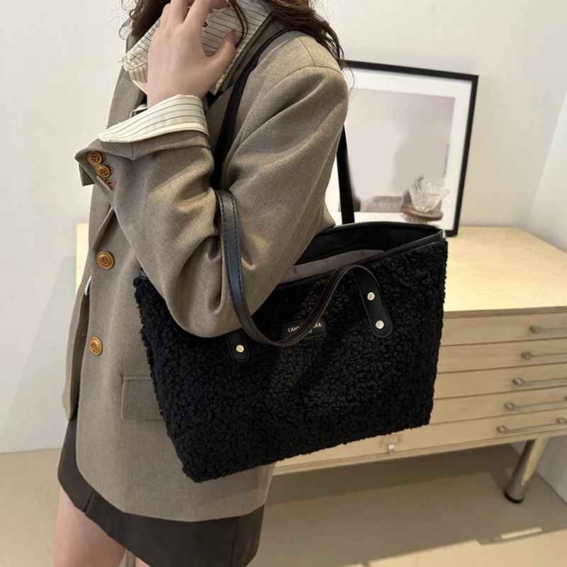Woman carrying a black plush tote shoulder bag